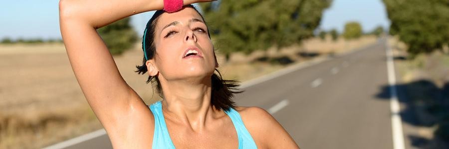 Woman sweating on run in hot weather